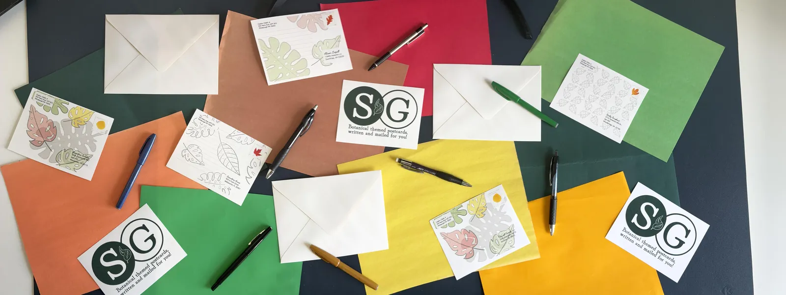 The desk where the cards are made — envelopes, pens and finished cards